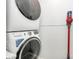 Modern laundry room with stacked washer and dryer, plus Dyson vacuum cleaner at 17546 Westmill Ln, Charlotte, NC 28277