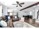 Bright, open living room featuring hardwood floors, leather seating, and seamless flow to the kitchen and dining areas at 17546 Westmill Ln, Charlotte, NC 28277