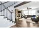 Open living space featuring a stone fireplace, comfortable leather seating, and staircase at 17546 Westmill Ln, Charlotte, NC 28277