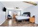 Spacious main bedroom featuring light-grey walls, ceiling fan and wood floors at 17546 Westmill Ln, Charlotte, NC 28277
