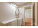 A view of a brightly lit bathroom featuring a vanity with cupboards, a mirror, and a doorway to another room at 1773 Hunters Trl, Rock Hill, SC 29732