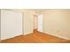 This bedroom has a closet, an entrance to the next room, cream colored walls, and light-colored hardwood floors at 1773 Hunters Trl, Rock Hill, SC 29732