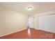 Bedroom with laminate flooring, closet with sliding doors and entry to private bathroom at 1773 Hunters Trl, Rock Hill, SC 29732