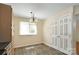 Dining area featuring an ornate light fixture, laminate flooring and closet at 1773 Hunters Trl, Rock Hill, SC 29732
