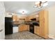 Traditional kitchen featuring wood cabinets, tile backsplash, laminate countertops and black appliances at 1773 Hunters Trl, Rock Hill, SC 29732