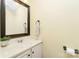 Bright half bathroom featuring a sink, vanity, mirror, and stylish towel rack at 225 Carrie Ct, Concord, NC 28027