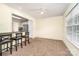 Bright dining area featuring plush carpet, a ceiling fan, and a pass-through to the kitchen at 225 Carrie Ct, Concord, NC 28027