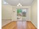Bright dining area leading to a wooden deck through sliding glass doors, featuring hardwood floors at 225 Carrie Ct, Concord, NC 28027