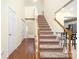 Inviting foyer showcasing hardwood floors, a carpeted staircase, and a view into adjacent rooms at 225 Carrie Ct, Concord, NC 28027