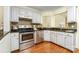 Well-equipped kitchen featuring stainless steel appliances, granite countertops, and mosaic tile backsplash at 225 Carrie Ct, Concord, NC 28027