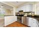 Galley kitchen with stainless steel appliances, granite countertops, and mosaic tile backsplash at 225 Carrie Ct, Concord, NC 28027