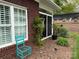Charming exterior with landscaped garden, sliding glass door, and brick facade at 227 Crystal Springs Ln, Shelby, NC 28150