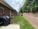 Well-maintained backyard with a brick wall and privacy fence, offering a serene outdoor space at 227 Crystal Springs Ln, Shelby, NC 28150