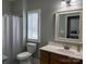 Bathroom featuring light wood vanity, white fixtures and shower with curtain at 227 Crystal Springs Ln, Shelby, NC 28150