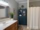 Bathroom featuring cabinet for storage, light wood vanity and shower with white curtain at 227 Crystal Springs Ln, Shelby, NC 28150