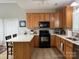 Bright kitchen features stainless steel appliances, light wood cabinets, and a white countertop island at 227 Crystal Springs Ln, Shelby, NC 28150