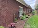 Detailed landscaping featuring a variety of plants and mulch beds surrounds the home's perimeter at 227 Crystal Springs Ln, Shelby, NC 28150