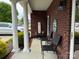 Inviting front porch with brick facade and comfortable seating at 227 Crystal Springs Ln, Shelby, NC 28150