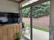 Sunroom features sliding glass door to backyard patio and a cabinet to store items at 227 Crystal Springs Ln, Shelby, NC 28150