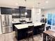 Modern kitchen featuring dark cabinetry, stainless steel appliances, and a large center island with quartz countertops at 2315 Doby Creek Ln # 77, Charlotte, NC 28262