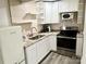 Well-equipped kitchen with granite countertops, stainless steel appliances, white cabinetry and new laminate flooring at 2315 Doby Creek Ln # 77, Charlotte, NC 28262