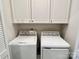 Convenient laundry room with washer, dryer, and upper cabinets at 2315 Doby Creek Ln # 77, Charlotte, NC 28262