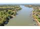 Stunning aerial view showcasing waterfront property, private docks, and lush trees on a sunny day at 234 Winding Shore Rd, Troutman, NC 28166