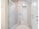 Bright bathroom featuring a glass-enclosed shower and white cabinets at 234 Winding Shore Rd, Troutman, NC 28166