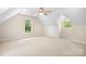 Spacious bedroom featuring neutral carpet, ceiling fan, natural light and built-in storage at 234 Winding Shore Rd, Troutman, NC 28166