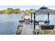 A dock extends into the lake, featuring a covered boat slip and gazebo with outdoor seating at 234 Winding Shore Rd, Troutman, NC 28166