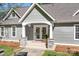 Inviting entryway featuring a decorative door, stone pillars and manicured flower beds at 234 Winding Shore Rd, Troutman, NC 28166