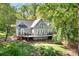 A home surrounded by lush greenery features an expansive outdoor living space at 234 Winding Shore Rd, Troutman, NC 28166
