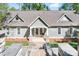 Welcoming home showcasing a covered front porch, stone accents, and well-kept landscaping at 234 Winding Shore Rd, Troutman, NC 28166