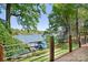 Lake view from back deck with metal railing and trees overlooking the water at 234 Winding Shore Rd, Troutman, NC 28166