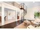 Open living area with spiral staircase, dark wood floors, and natural light at 234 Winding Shore Rd, Troutman, NC 28166
