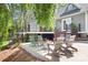 A patio area is shown with chairs around a fire pit with home in background at 234 Winding Shore Rd, Troutman, NC 28166