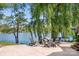 The patio features chairs around a fire pit with waterfront views at 234 Winding Shore Rd, Troutman, NC 28166