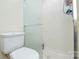 Bathroom showcasing a shower with glass doors and a toilet at 2429 Sugar Mill Rd, Charlotte, NC 28210