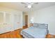 Bedroom with hardwood floors, double closets, a ceiling fan, and a queen-sized bed at 2429 Sugar Mill Rd, Charlotte, NC 28210