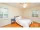 Neutral bedroom showcasing hardwood floors, ceiling fan, and natural light at 2429 Sugar Mill Rd, Charlotte, NC 28210
