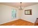 Inviting dining room featuring hardwood floors, chandelier, and natural light from a large window at 2429 Sugar Mill Rd, Charlotte, NC 28210
