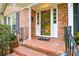 Close up of front entrance and tiled stoop featuring brick facade and traditional design elements at 2429 Sugar Mill Rd, Charlotte, NC 28210