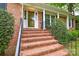 Close up of front entrance showing the brick steps, front door, and manicured landscaping at 2429 Sugar Mill Rd, Charlotte, NC 28210