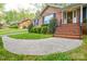 View of the brick front steps leading to the front entrance with white trim and glass door at 2429 Sugar Mill Rd, Charlotte, NC 28210