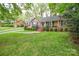 Well-maintained front yard with lush green lawn leading to the brick home with black shutters at 2429 Sugar Mill Rd, Charlotte, NC 28210