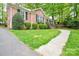 Low angle view showing the green lawn, sidewalk, and brick facade of the house at 2429 Sugar Mill Rd, Charlotte, NC 28210