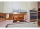 Well-maintained kitchen featuring a stainless steel cooktop and stainless steel oven at 2429 Sugar Mill Rd, Charlotte, NC 28210