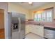 Well-lit kitchen featuring a stainless steel refrigerator and stainless steel dishwasher at 2429 Sugar Mill Rd, Charlotte, NC 28210