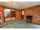 Enclosed patio with brick walls, sliding glass door to living room, and a TV on a stand at 2429 Sugar Mill Rd, Charlotte, NC 28210
