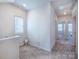 Upstairs hallway featuring neutral carpeting, a window, and views of bedrooms at 2555 Ruby Dixon Crossing Dr # 16, Gastonia, NC 28056